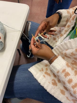 Close up of hands that are knitting