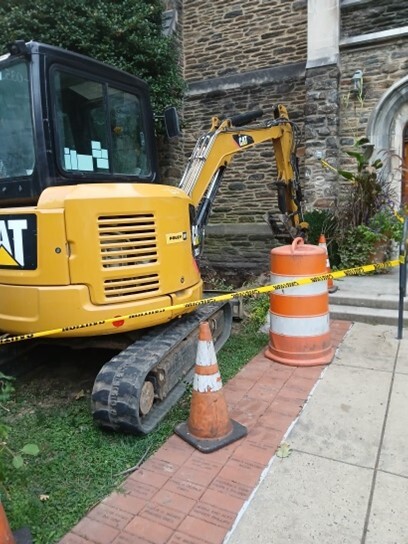 Wide view of backhoe in front of the library